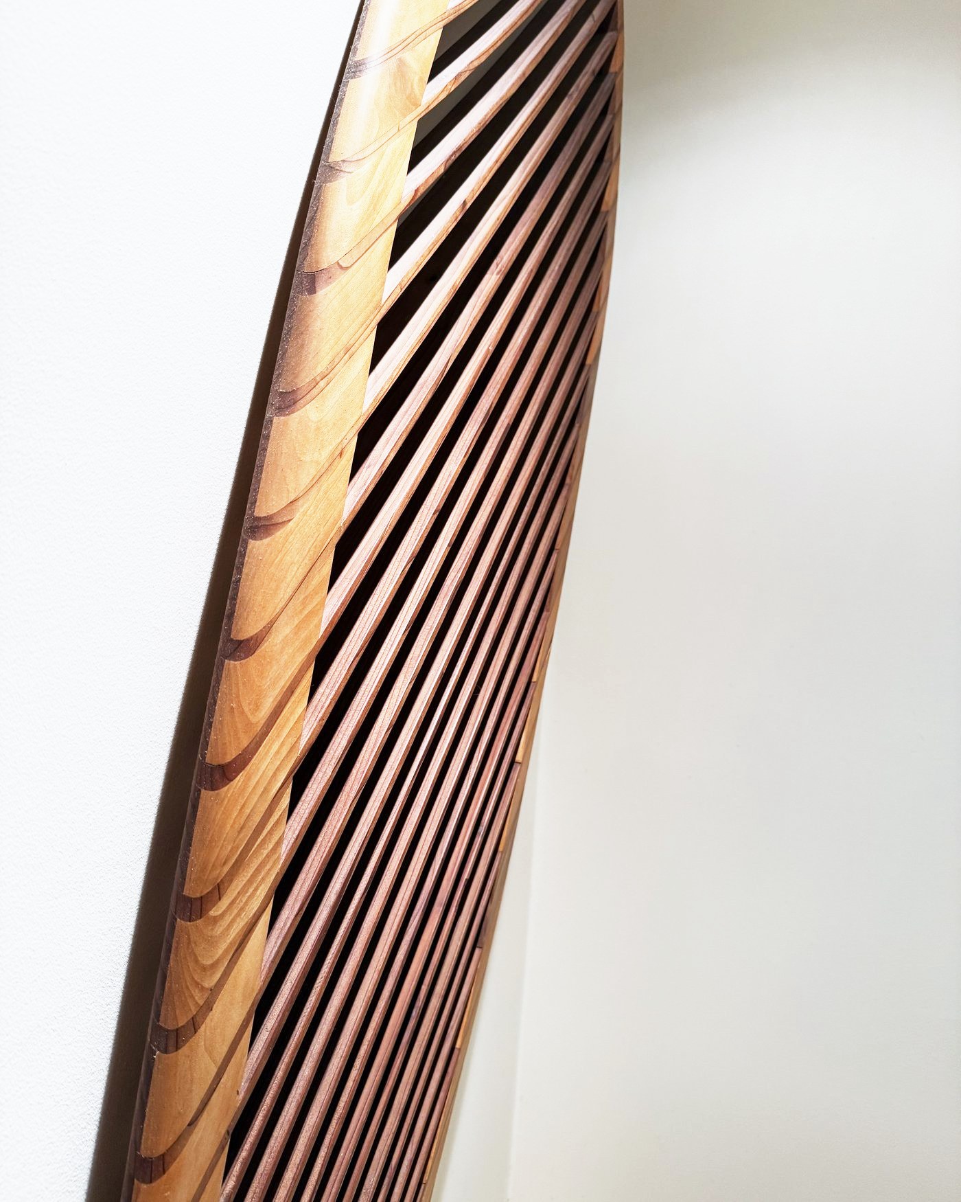 Side view along the laminated cedar rail and redwood slats.